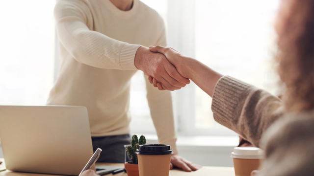 two people are handshaking