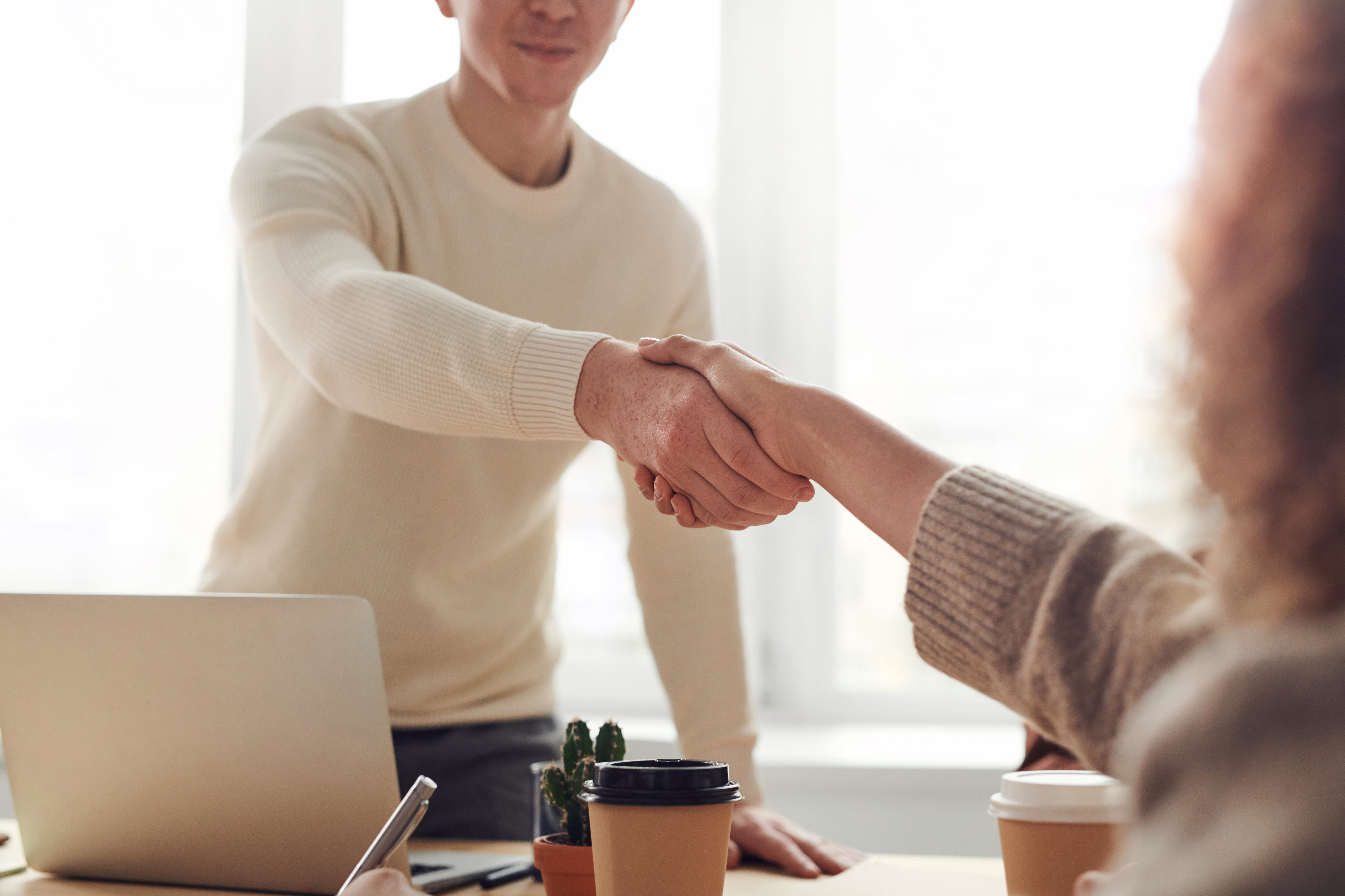 two people are handshaking